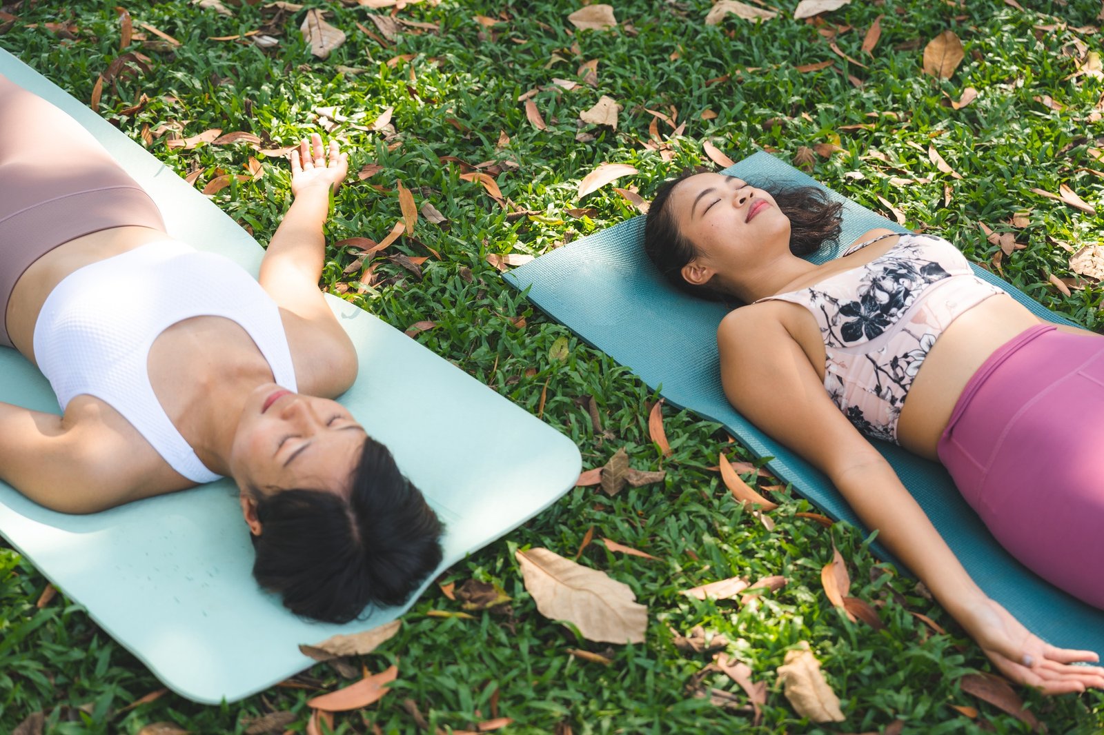 Group of people doing yoga exercises by the lake at morning outdoor, Woman practicing yoga
